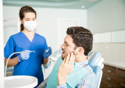 mid-adult-man-suffering-from-toothache-while-looking-dentist-with-tools-clinic_662251-2569